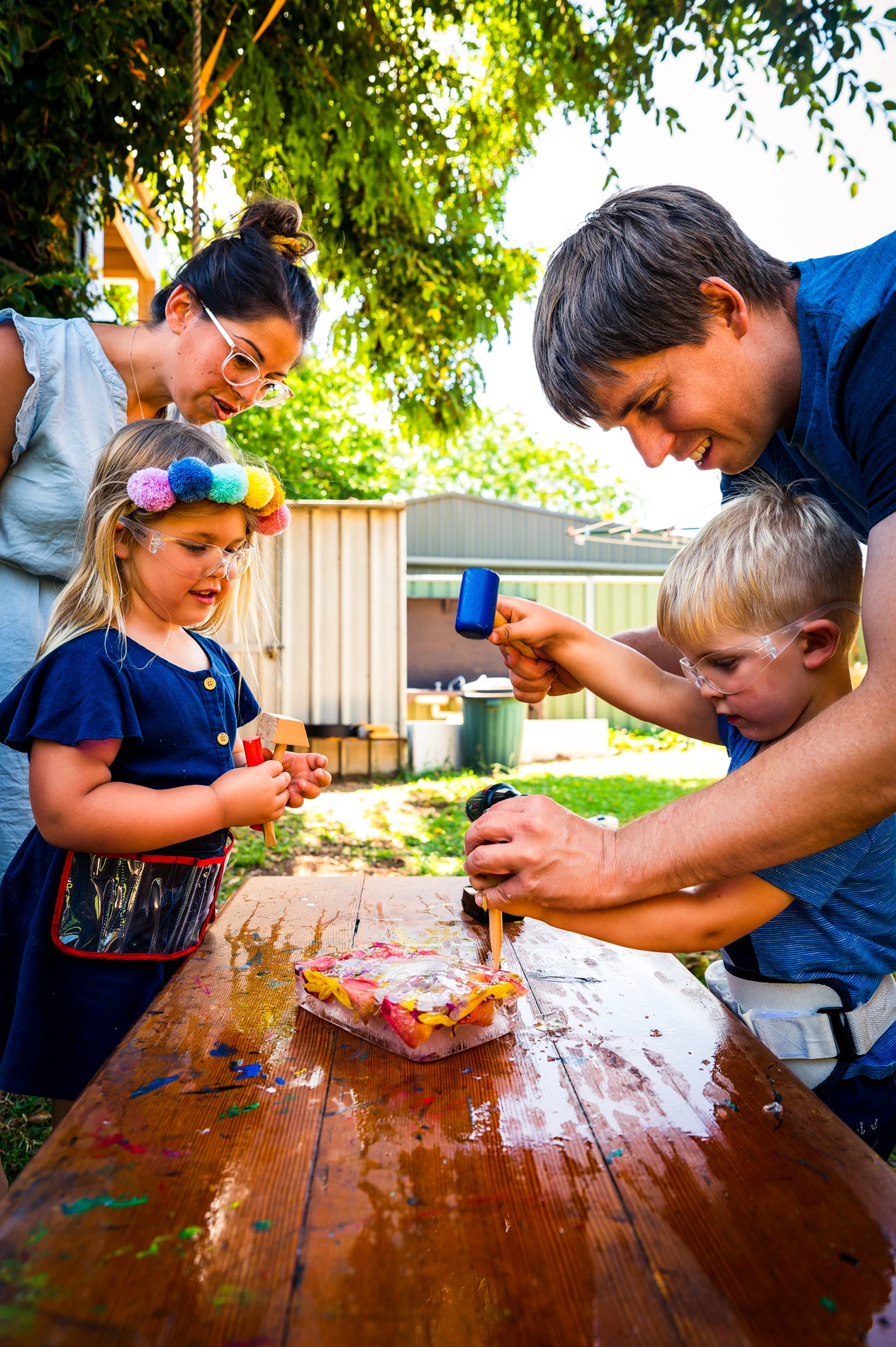 Why Lifestyle Family Photos Matter: Authentically Capturing Your Connections With Care 1 Adults And Children Crafting With Frozen Material Outdoors On A Wooden Table In A Garden.