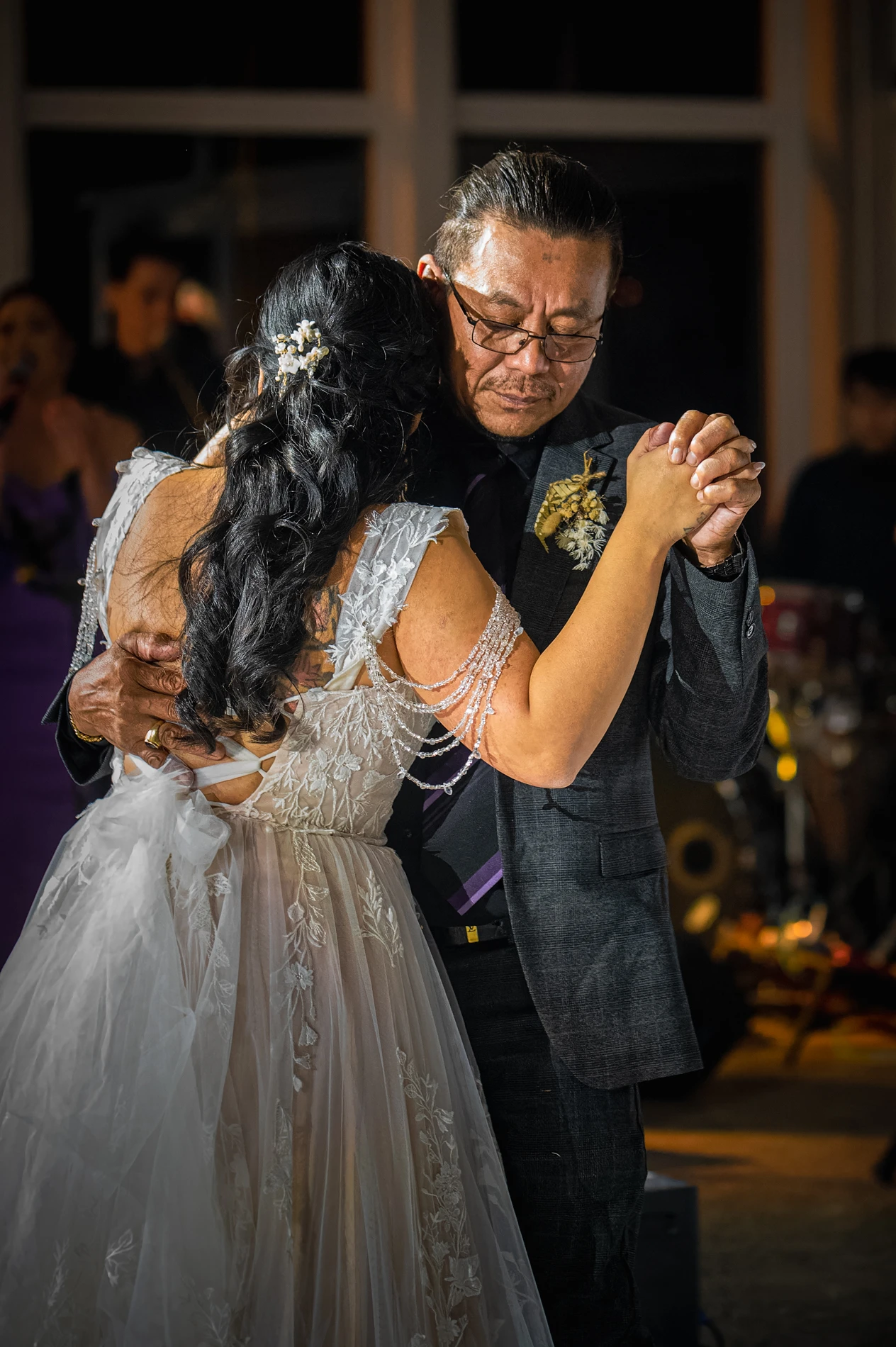 Couple Dancing Closely; Woman In Lace Dress, Man In Suit, Dimly Lit Dance Floor.
