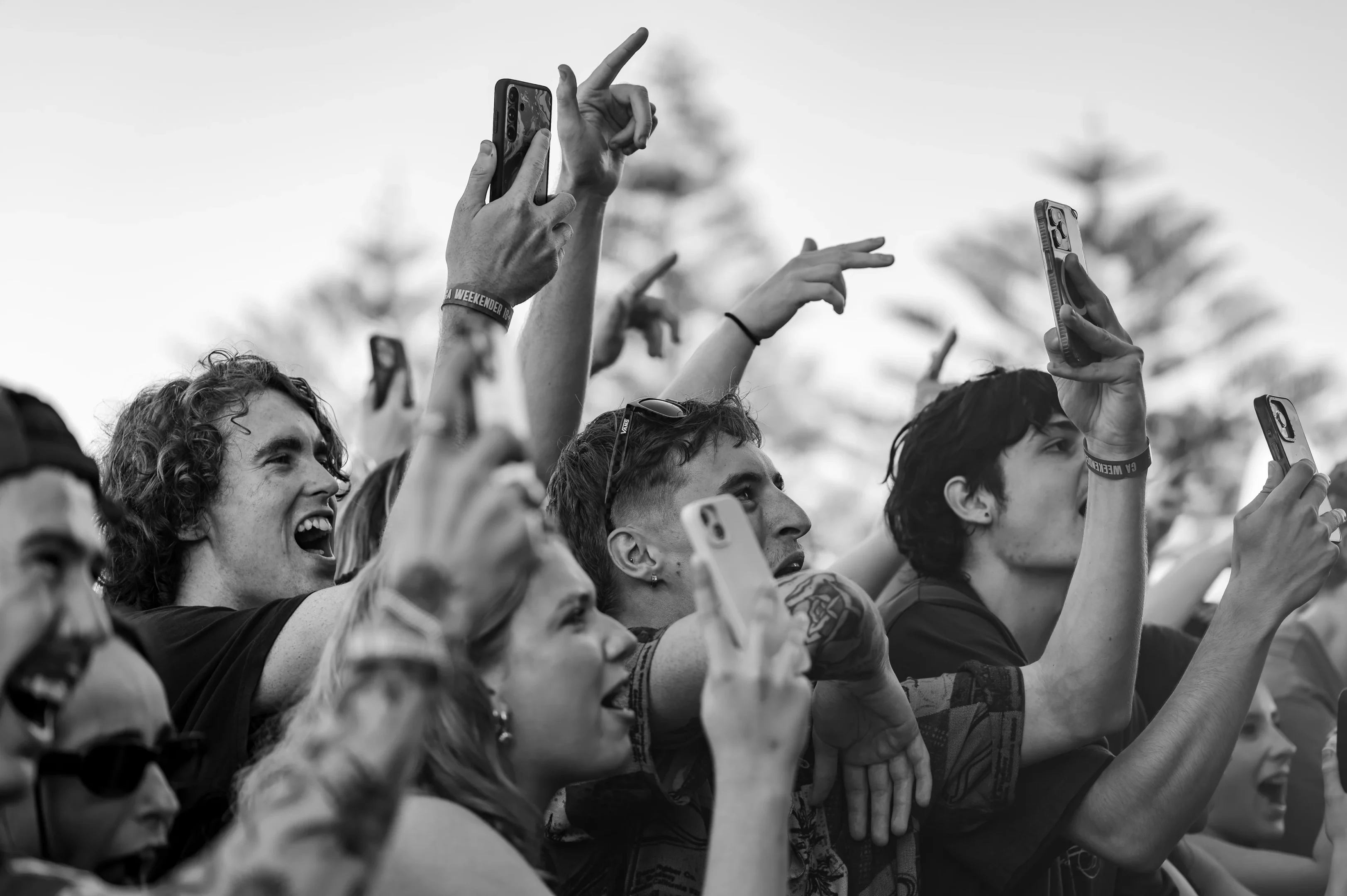 People At A Live Event Capturing The Moment On Smartphones With Excitement And Engagement.